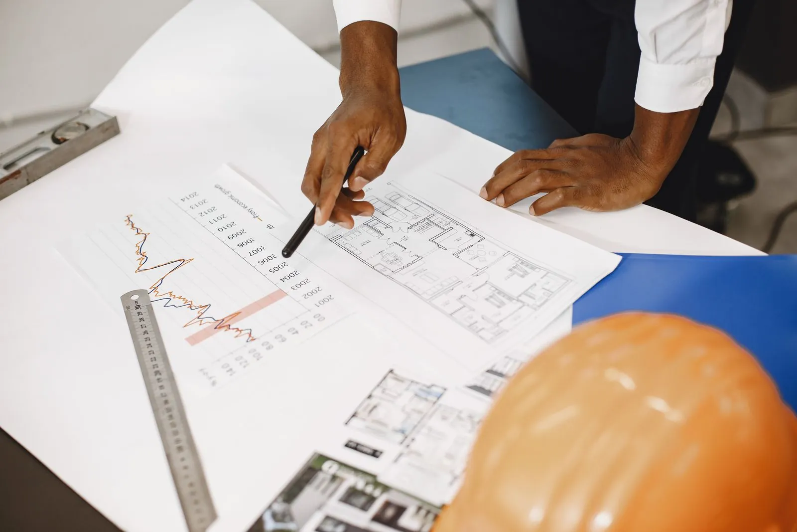 Engineers reviewing drawings around a table